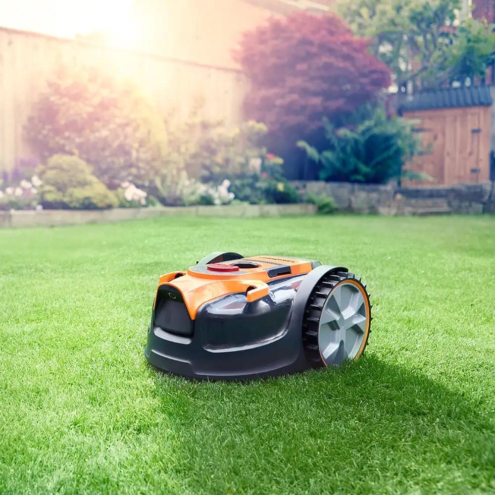 A robot lawnmower on a neatly cut lawn